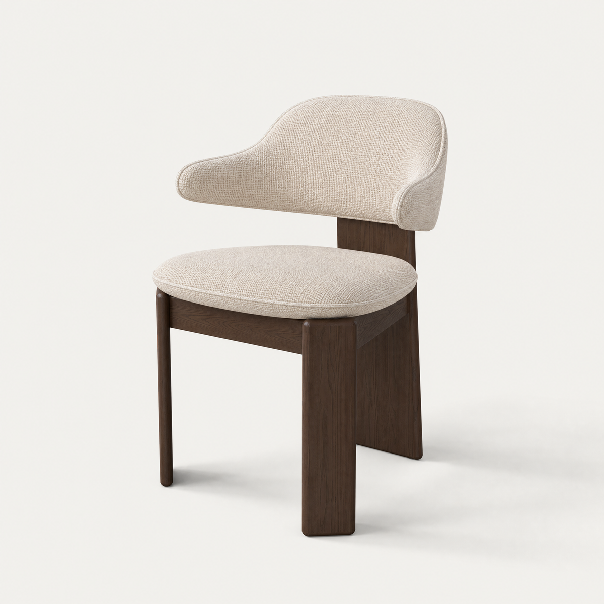 The Gaba Dining Armchair by Valerio Sommella combines a sculptural Dark Oak frame with a softly upholstered wraparound backrest, available at ACERKA Miami.