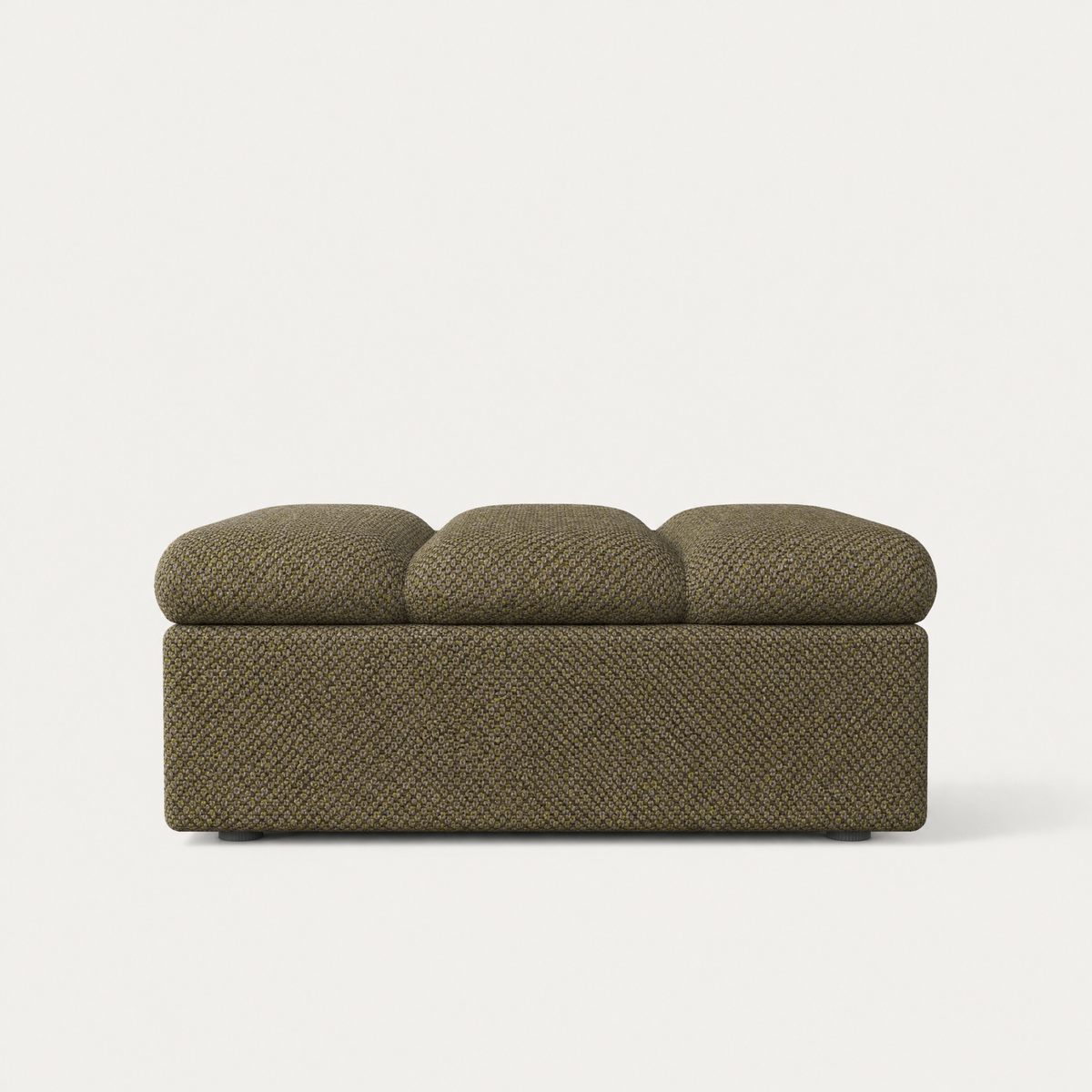 An upholstered bench with a textured herringbone fabric in an olive green color, featuring three rounded back cushions on top, set against a plain off-white background. Designed by Valerio Sommella for Acerka.