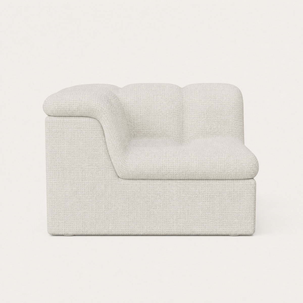 A modern low-profile accent chair upholstered in a light beige textured bouclé fabric, shown against a plain off-white background. Designed by Valerio Somella for Acerka