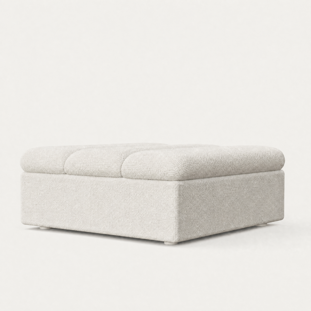 A square upholstered ottoman with a tufted top cushion and a low box base, shown on a clean white studio background.