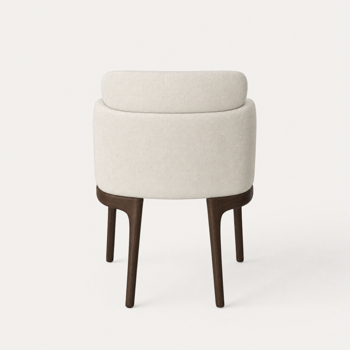 A sculptural wraparound shell and floating lumbar cushion define Ramón Esteve’s Sia Dining Chair, supported by tapered Dark Oak legs and showcased at ACERKA Miami.