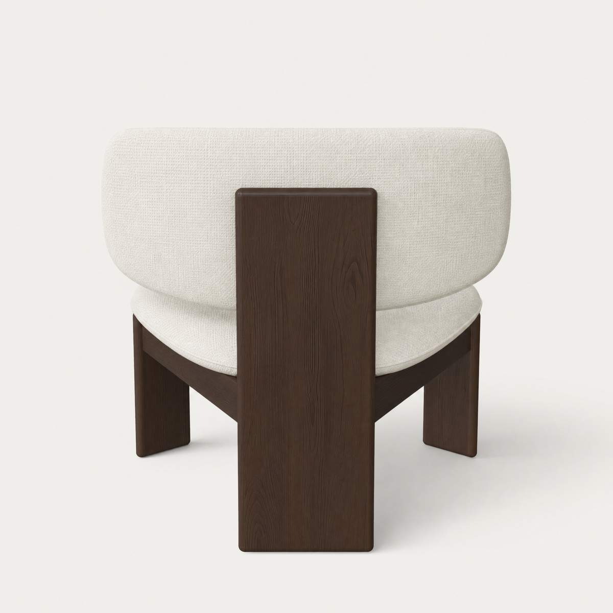 Rich Dark Oak surrounds the softly upholstered Gaba Lounge Chair by Valerio Sommella, creating a sculptural profile presented by ACERKA Miami.