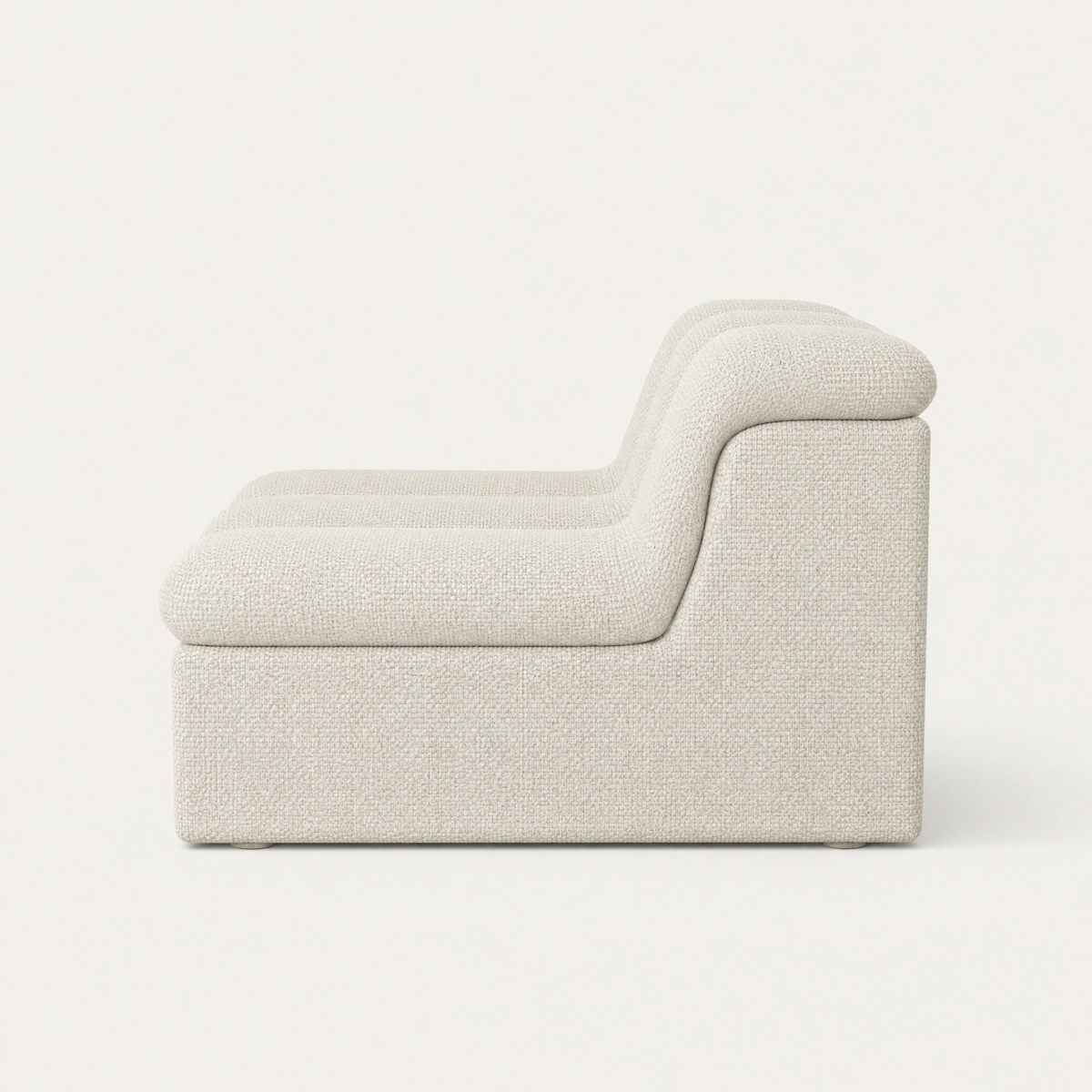 A modern low-profile accent chair upholstered in a textured off white fabric, shown from a side profile view against a clean off-white background. Designed by Valerio Sommella for Acerka.