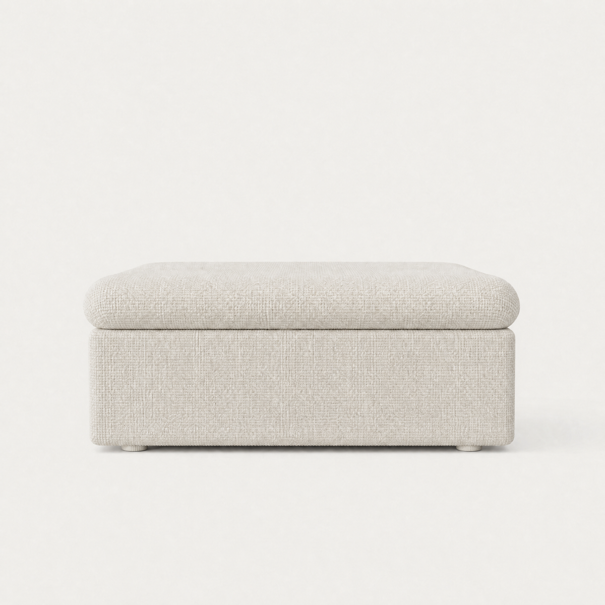 A square upholstered ottoman with a textured light white fabric, shown from a front-facing perspective against a clean white background.