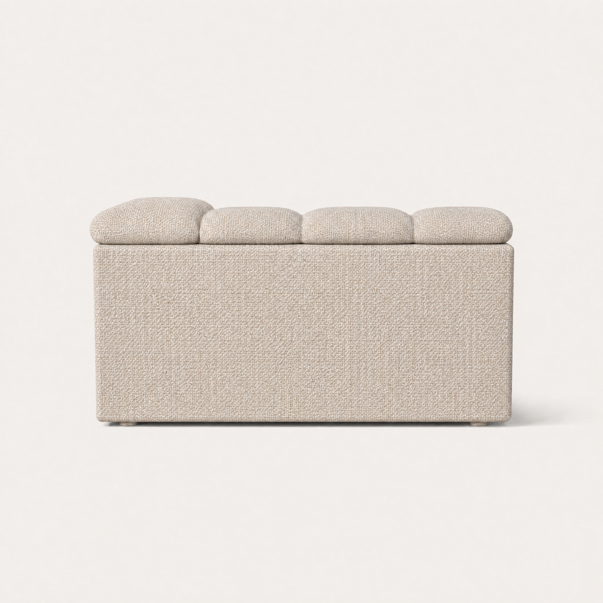 The Devi Left Arm Sofa Module features textured Stone Beige upholstery, rounded contours, and a distinctive padded armrest.