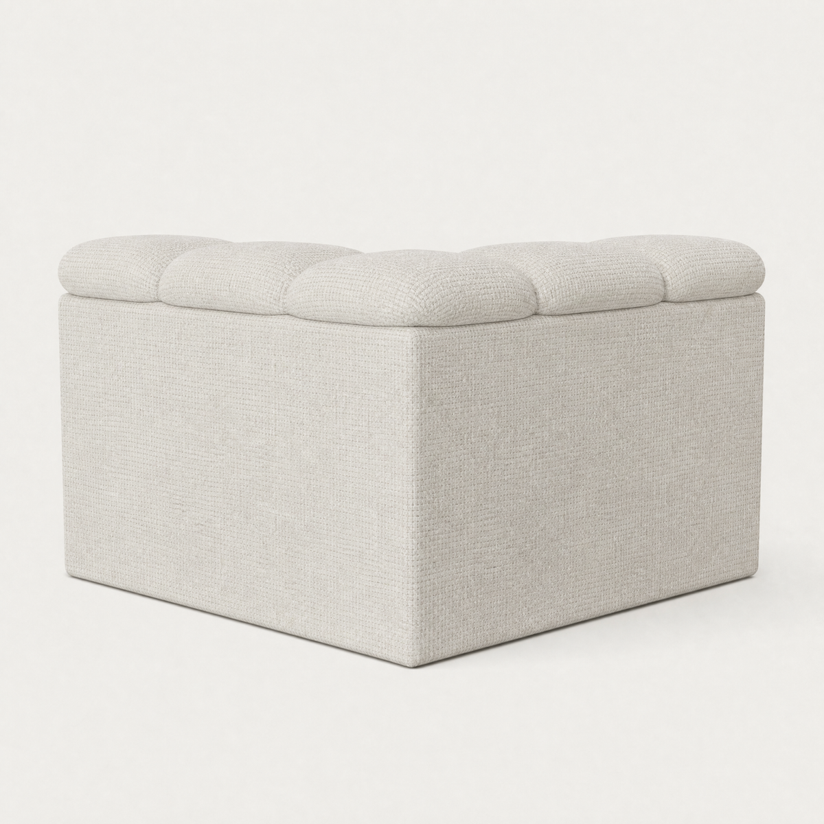 A light beige upholstered storage ottoman with a tufted lid, shown on a clean white background. Designed by Valerio Somella for Acerka