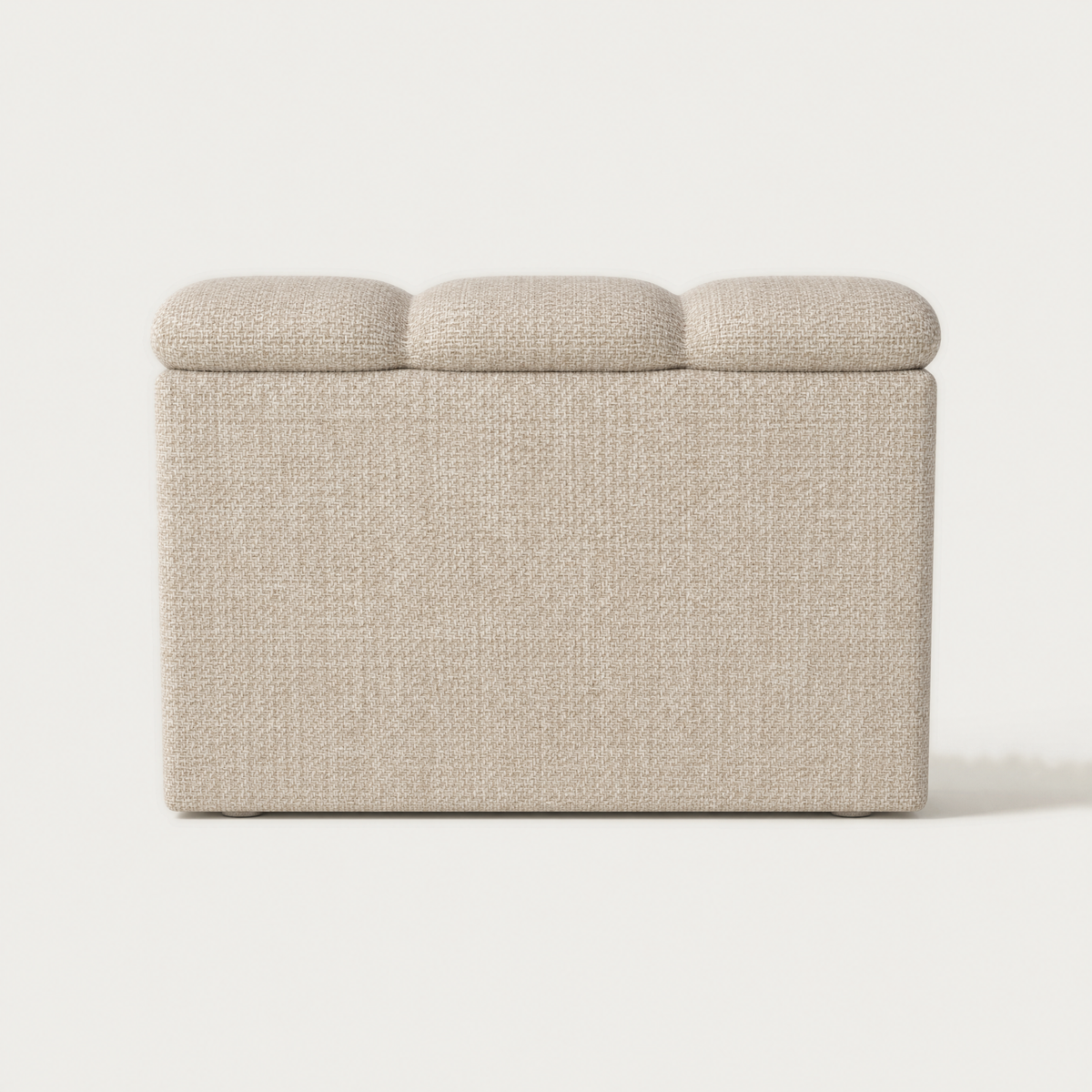 Back view of the modular section with a three-segment cushioned top, covered in a textured beige fabric, shown against a plain off-white background. Designed by Valerio Sommella for Acerka.