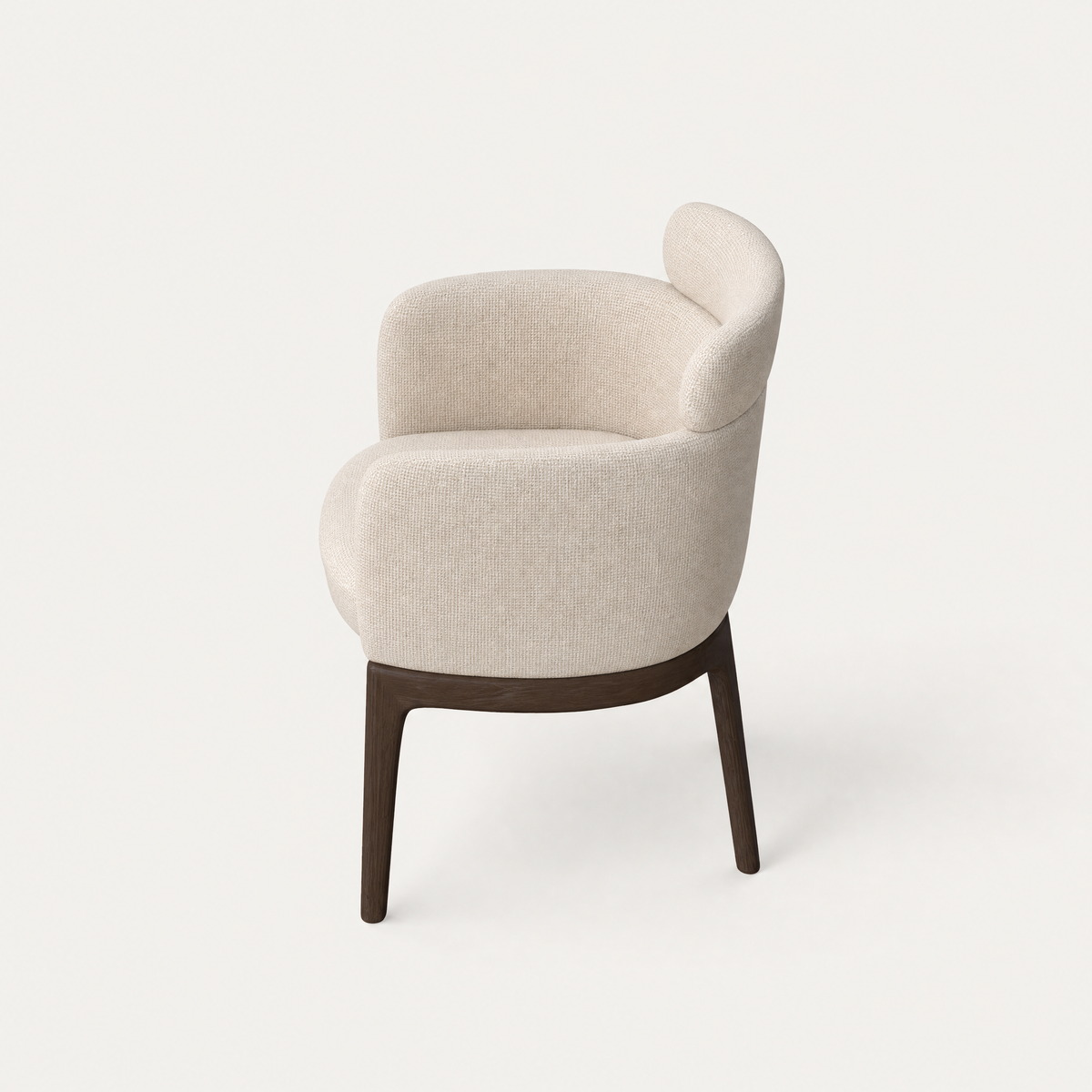 Designed by Ramón Esteve, the Sia Dining Chair pairs a sculptural wraparound form with slender Dark Oak supports in the ACERKA Miami collection.