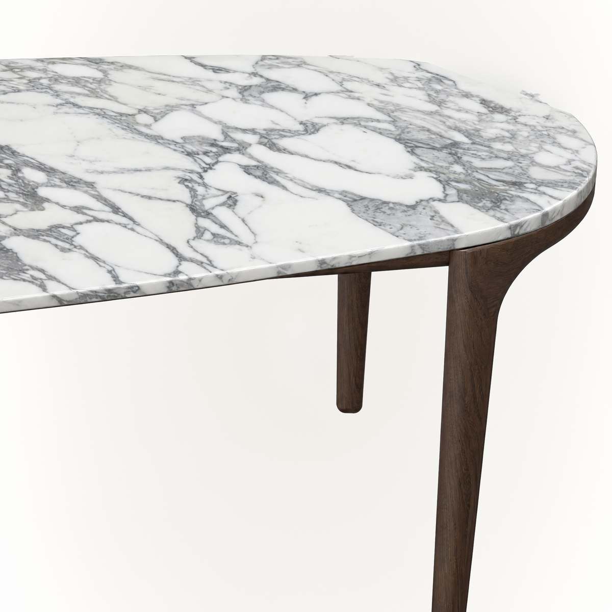 Expressive gray veining flows across the Italian marble top of ACERKA Miami’s Tcha Dining Table, contrasted by its clean Dark Oak frame.