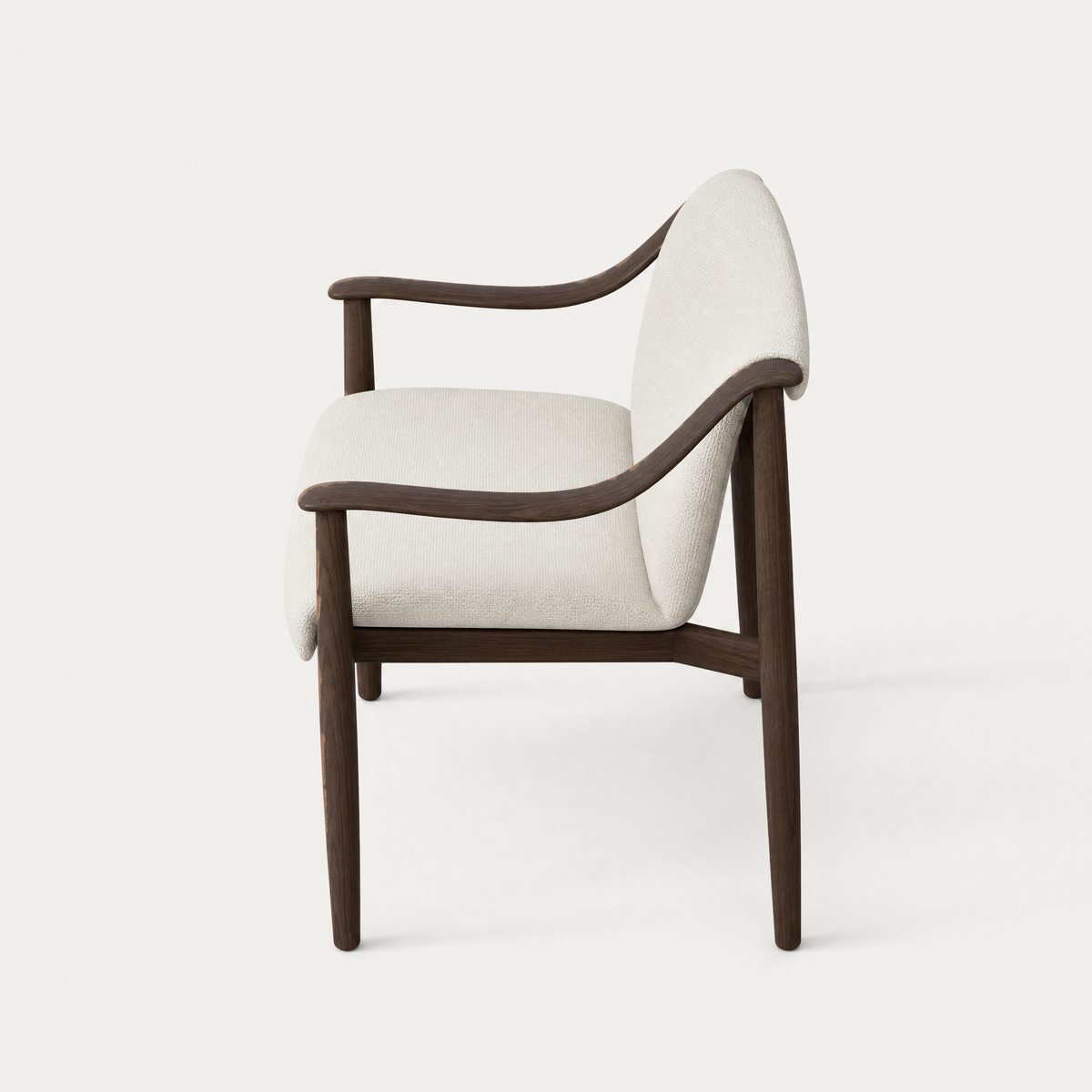 Designed by Ramón Esteve, the Tibeto Dining Chair at ACERKA Miami features sweeping oak armrests, slender legs, and substantial Alpine White upholstery.