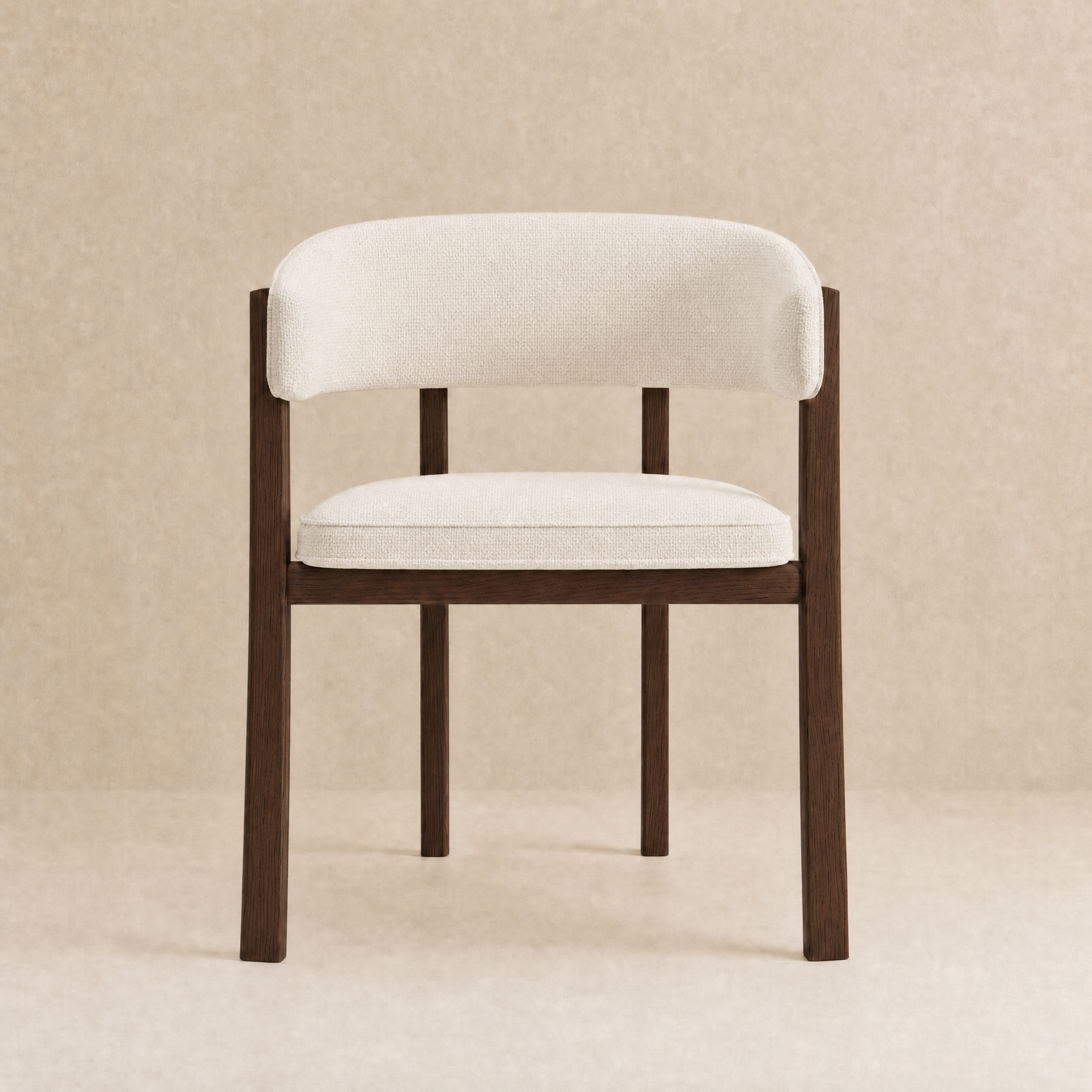 A modern accent chair with a curved backrest and seat cushion upholstered in off-white fabric, supported by a dark brown wooden frame, set against a neutral beige textured background.