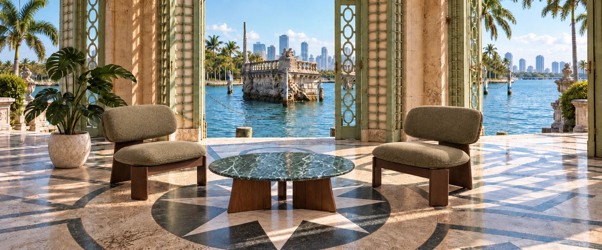 Contemporary lounge chairs and marble coffee table in a luxury waterfront patio setting.