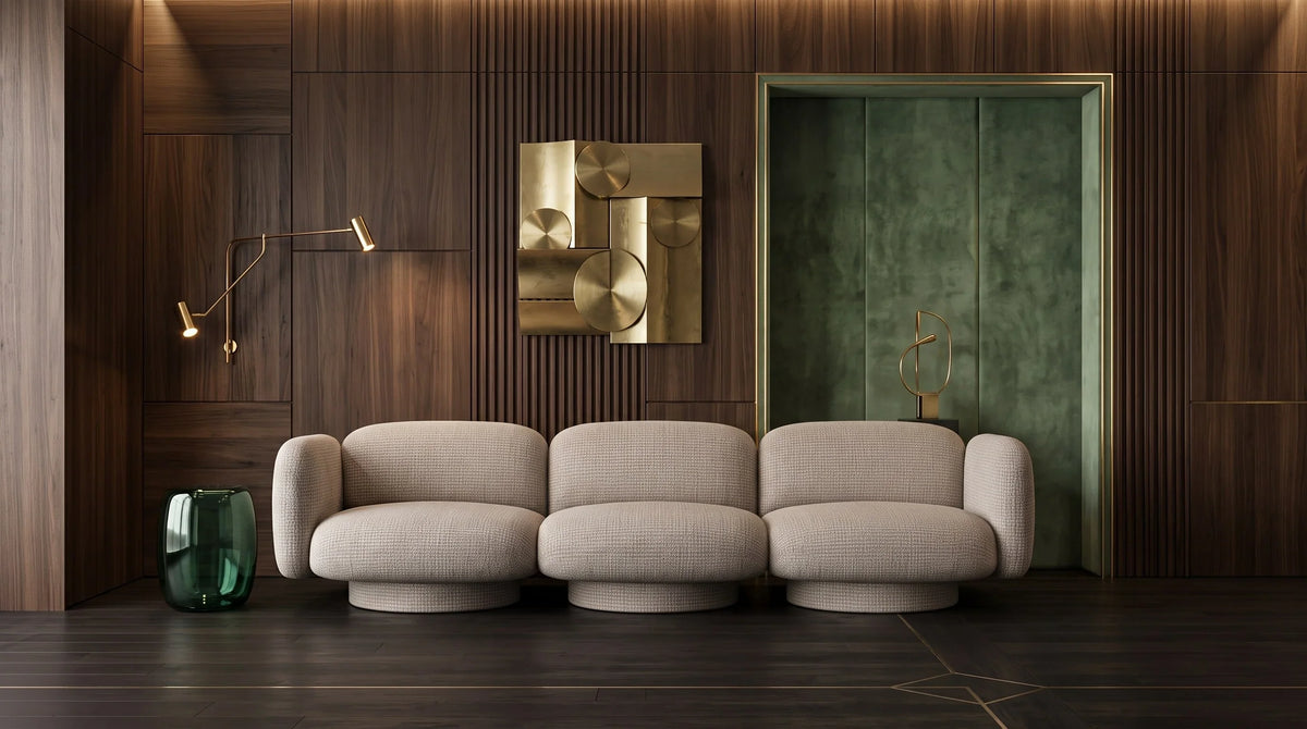 Modern beige modular sofa in a luxury room with dark wood walls and gold art.