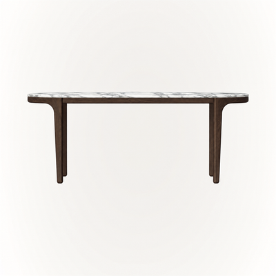 An elongated marble top with softly rounded edges defines the Tcha Dining Table at ACERKA Miami, supported by a clean architectural Dark Oak frame.