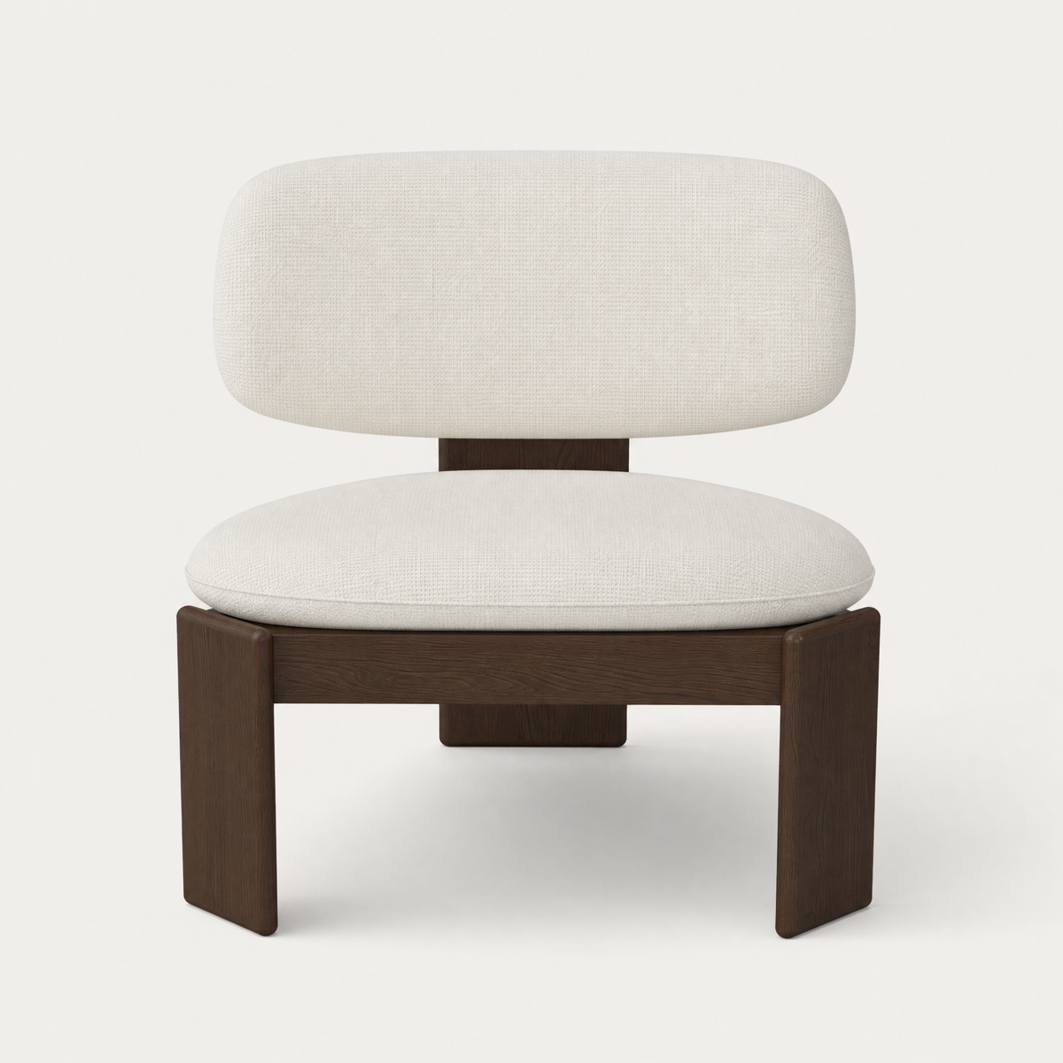 The Gaba Lounge Chair by Valerio Sommella features a generously padded seat, enveloping curved backrest, and solid Dark Oak frame, available at ACERKA Miami.