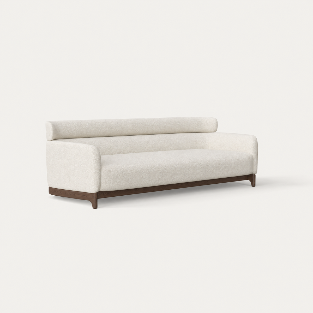 The Sia Large Sofa by Ramón Esteve pairs an enveloping Alpine White upholstered form with a sculptural Dark Oak base, available at ACERKA Miami.