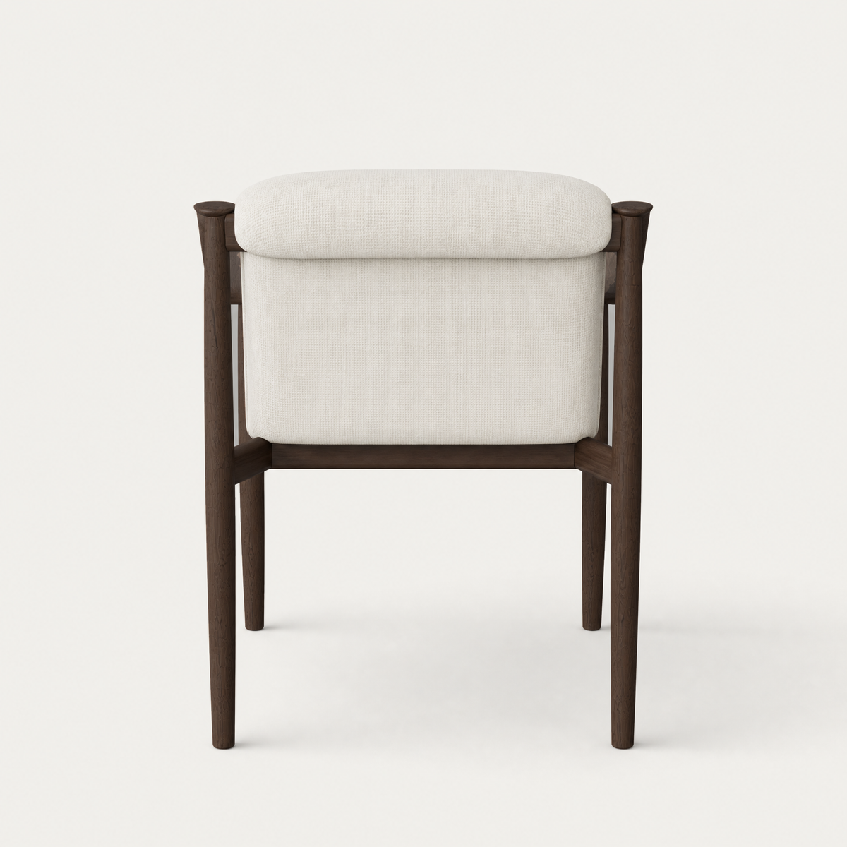 Sculpted Dark Oak surrounds the upholstered seat and rounded backrest of Ramón Esteve’s Tibeto Dining Chair, showcased by ACERKA Miami.