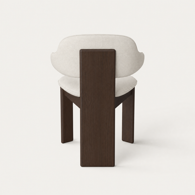 A curved upholstered backrest wraps around the Gaba Dining Armchair by Valerio Sommella, balanced by a solid Dark Oak frame and showcased at ACERKA Miami.