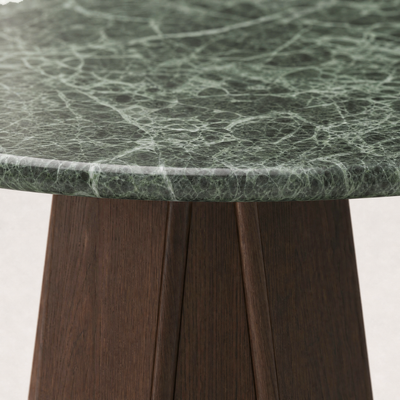 The Chuli Round Dining Table at ACERKA Miami features a circular Verde Alpi marble top with softly rounded edges and a distinctive geometric oak base.
