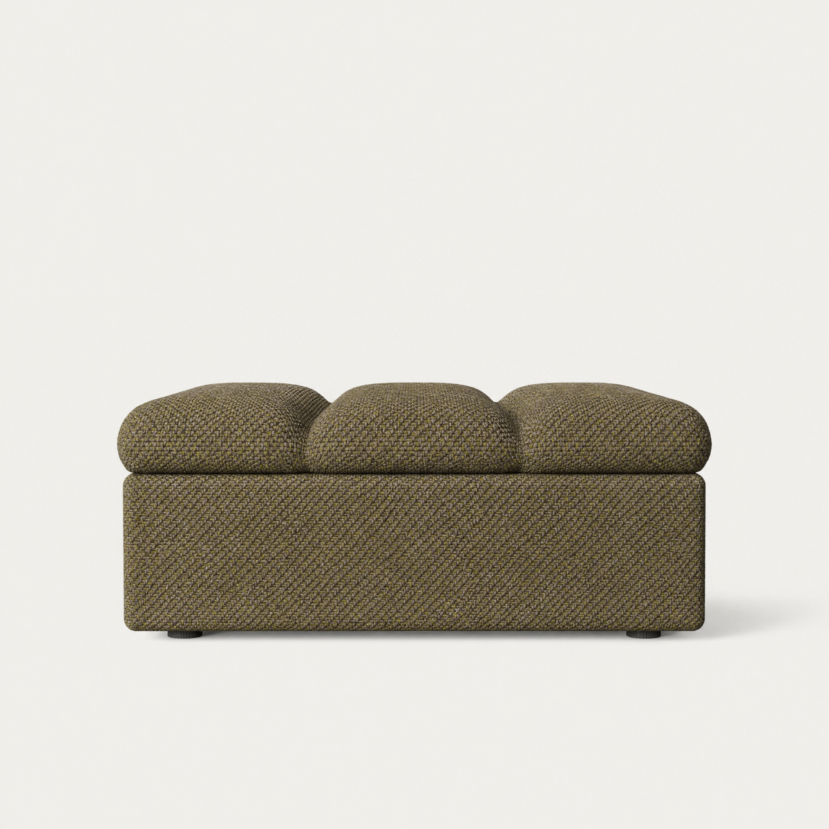 An upholstered stool with a three-cushion top and a textured woven fabric in a muted olive-brown color, shown against a plain light gray background. Designed by Valerio Sommella for Acerka.