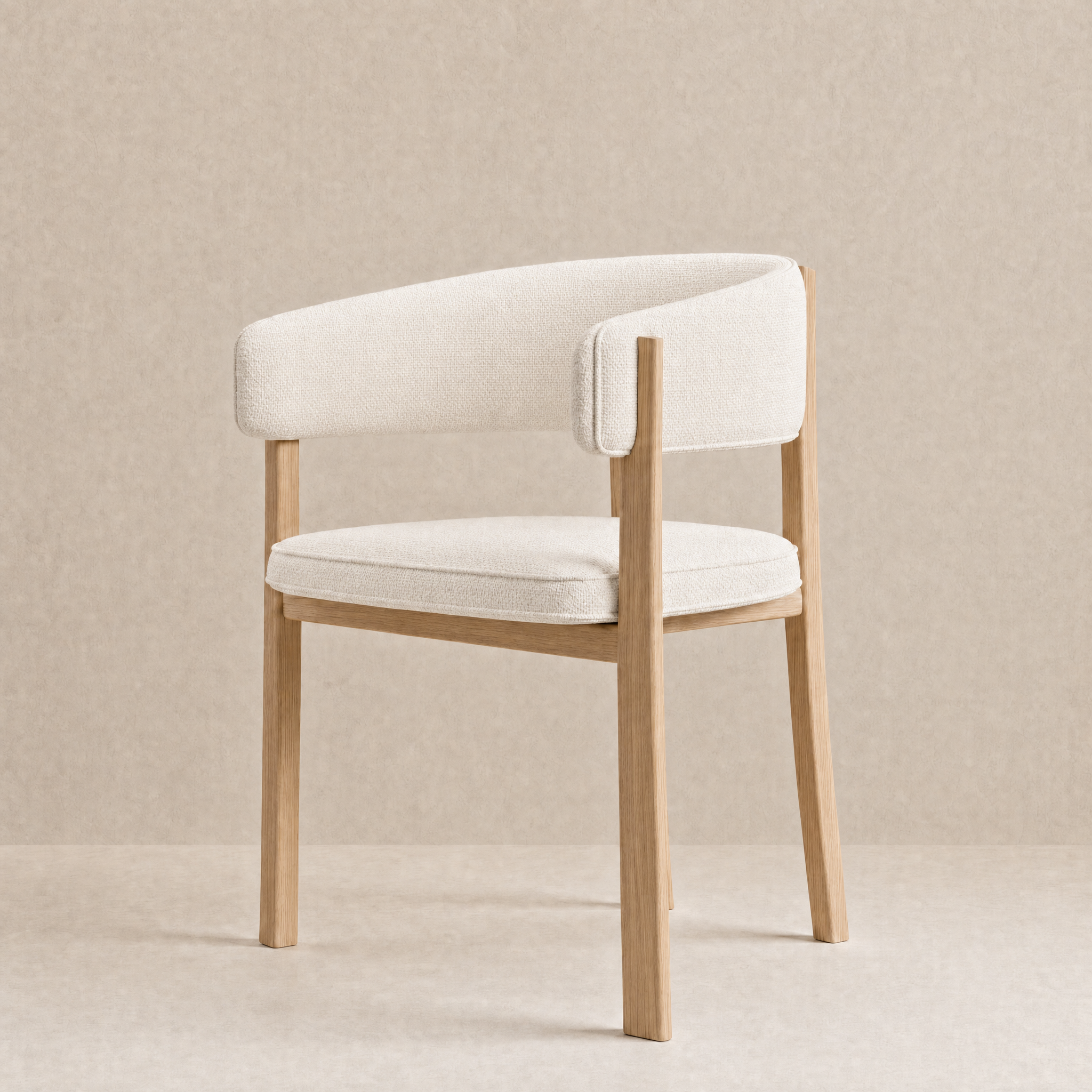A modern accent chair with a curved backrest and seat cushion upholstered in a warm off-white textured fabric, supported by a light natural oak wood frame, set against a neutral beige textured background.