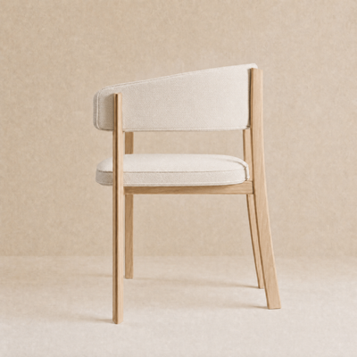 A modern accent chair with a light beige textured fabric seat and backrest, supported by a natural light wood frame, set against a matching beige textured background.