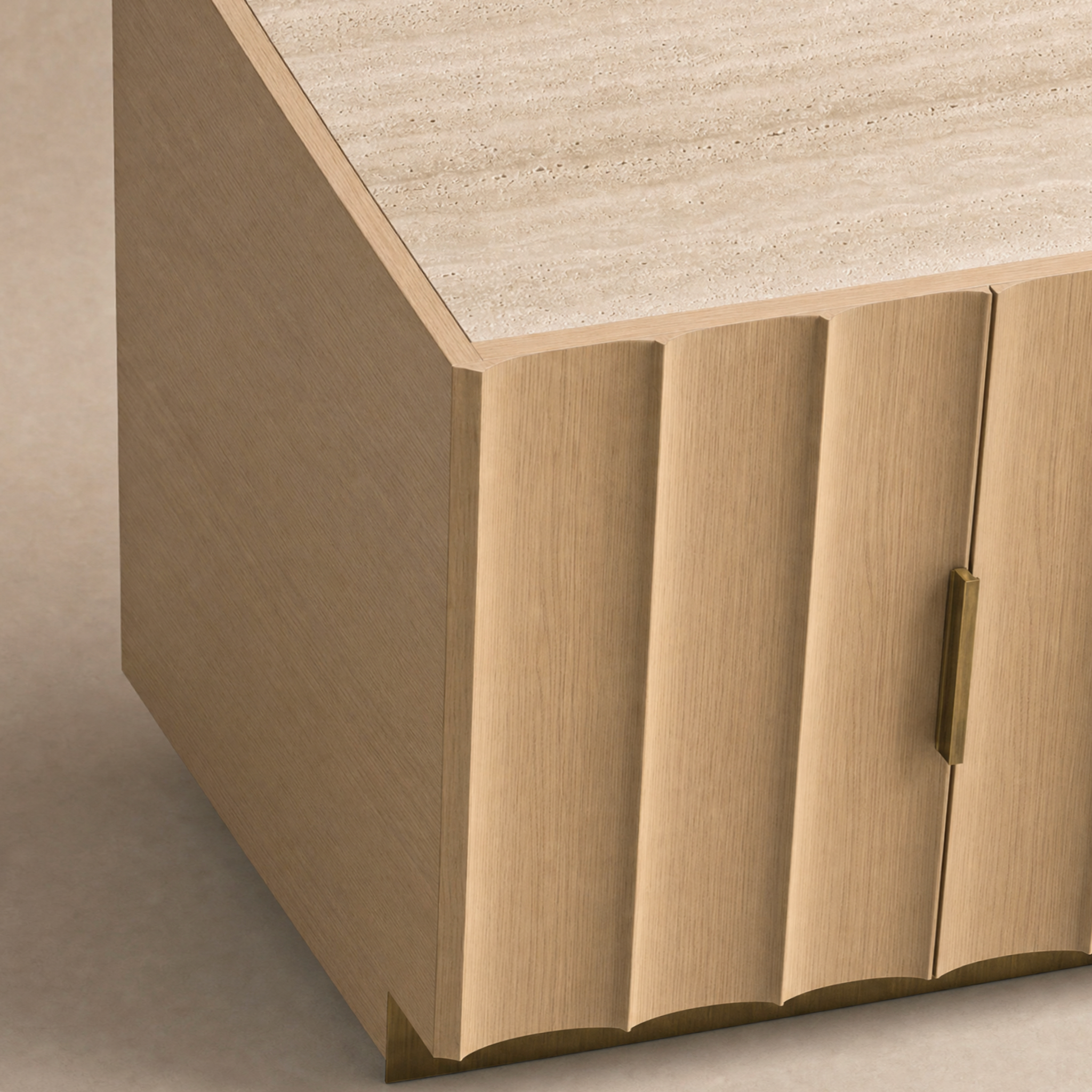 Close-up of a modern sideboard or cabinet corner with fluted panel doors in a light natural wood finish, a textured stone top, and a slim brass handle.