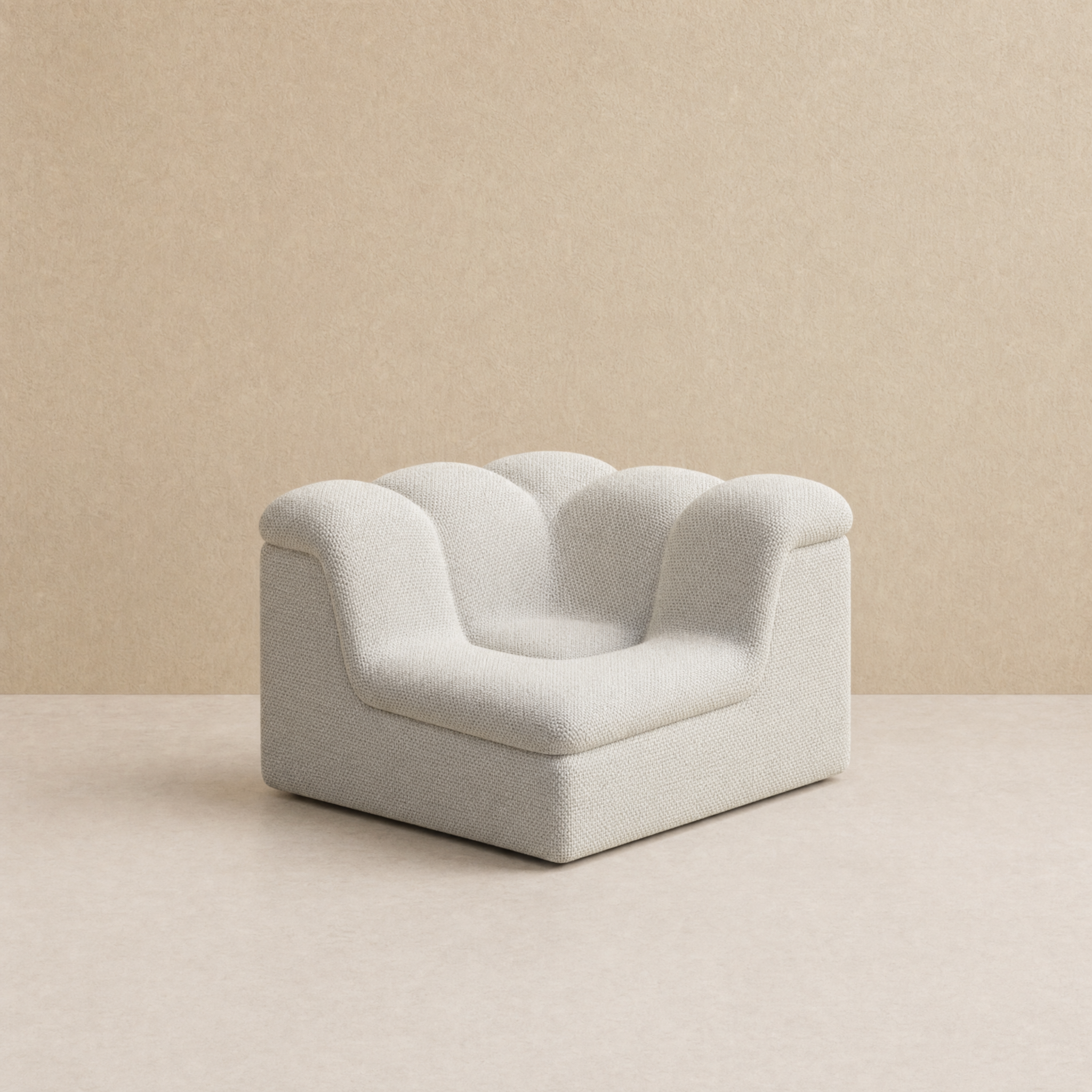 A modern low-profile accent chair upholstered in a textured light white fabric, featuring a sculptural, cloud-like backrest and rounded arms, set against a minimalist beige background.