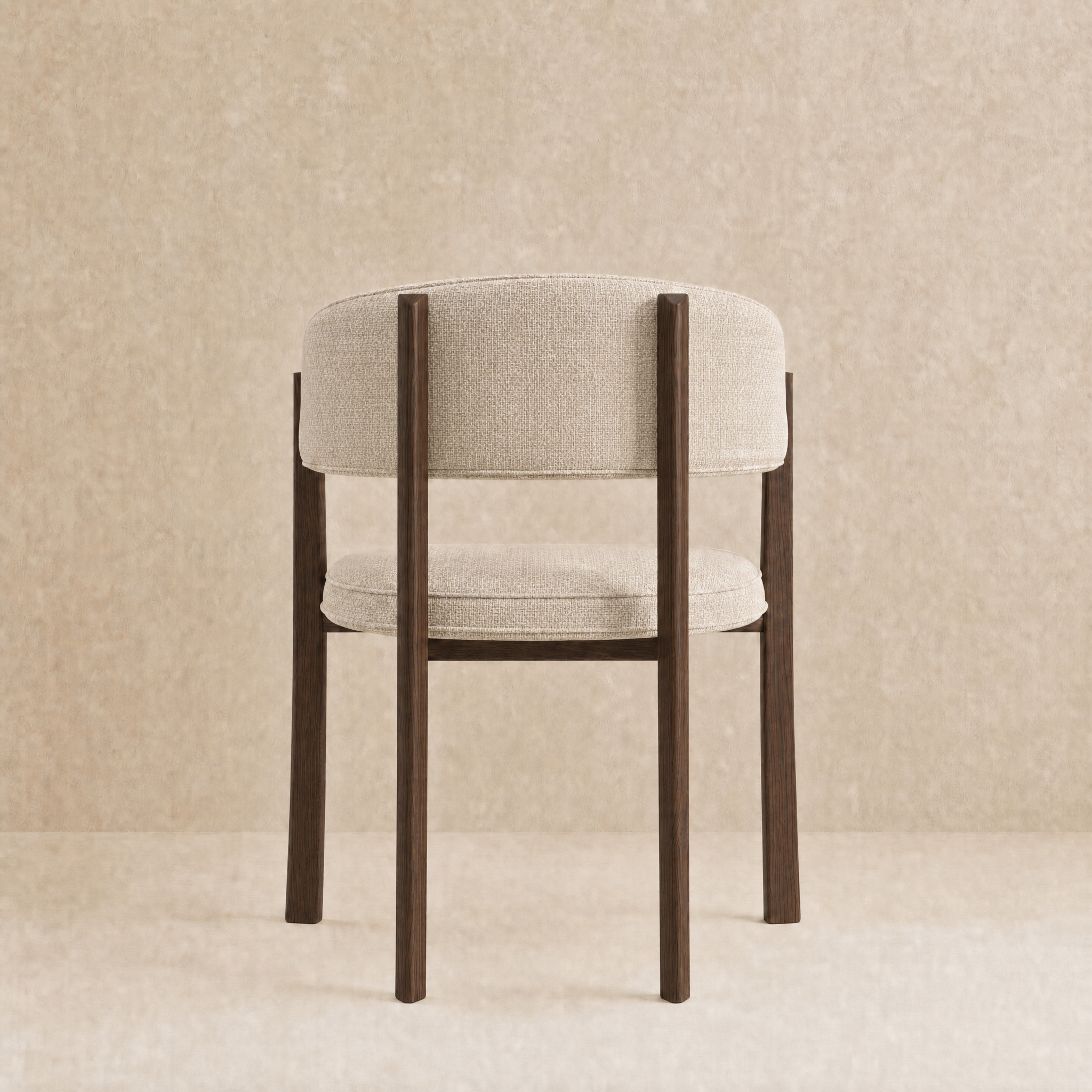 A modern accent chair with a light beige textured fabric cushioned seat and backrest, supported by a dark brown wooden frame with straight legs, set against a neutral beige textured background.